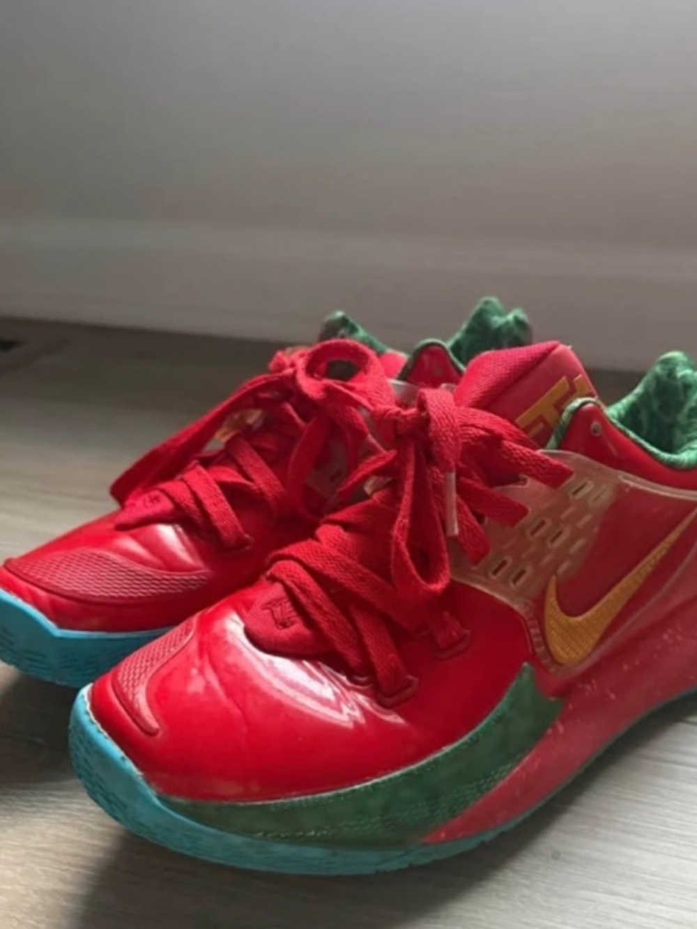 Nike Women's Red Sneakers with Gold Swoosh and Green Accents